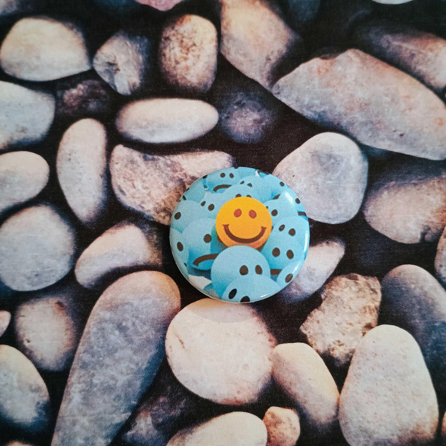 Yellow Smiley in a crowd of Blues pin badge